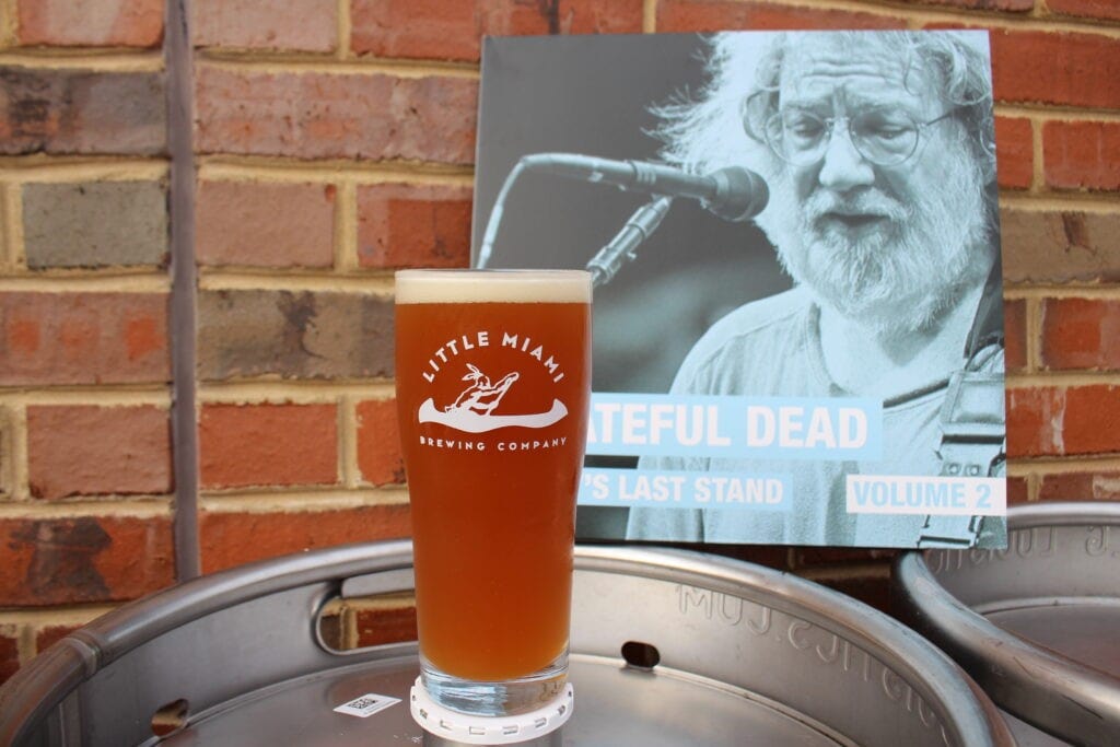 A glass of Little Miami Brewing Company's flavored beer A glass of Little Miami Brewing Company's beer in front of a Grateful Dead poster.