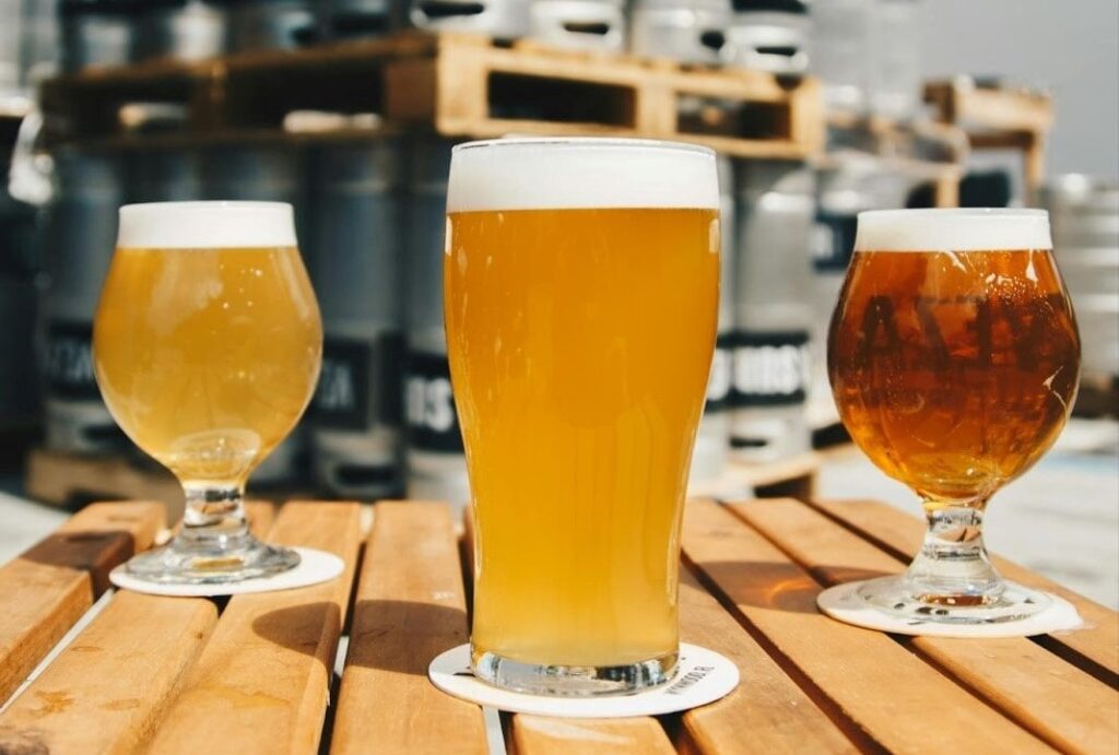 Three glasses of different flavored beers Three glasses of different flavored beers on a wooden table.