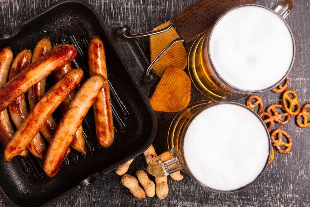 Grilled sausages, pretzels, and beer - the perfect party event spread. Grilled sausages, pretzels, and beer - the perfect party event spread.