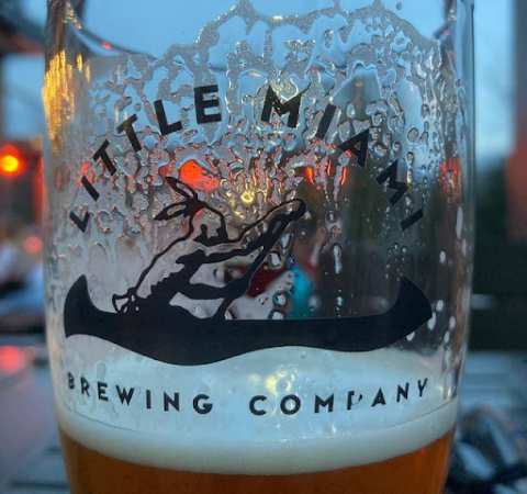 A glass of Little Miami Brewing Company's hazy IPA, showcasing its cloudy, golden hue.